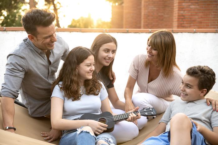 family gathering and playing the ukulele together